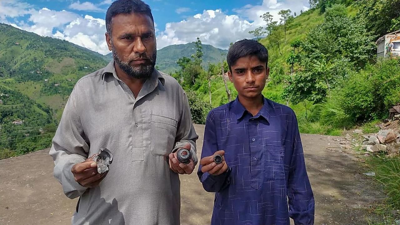 Villagers show parts of a mortar shell fired by Pakistani Army, at Shahpur in Poonch district. Credit: PTI