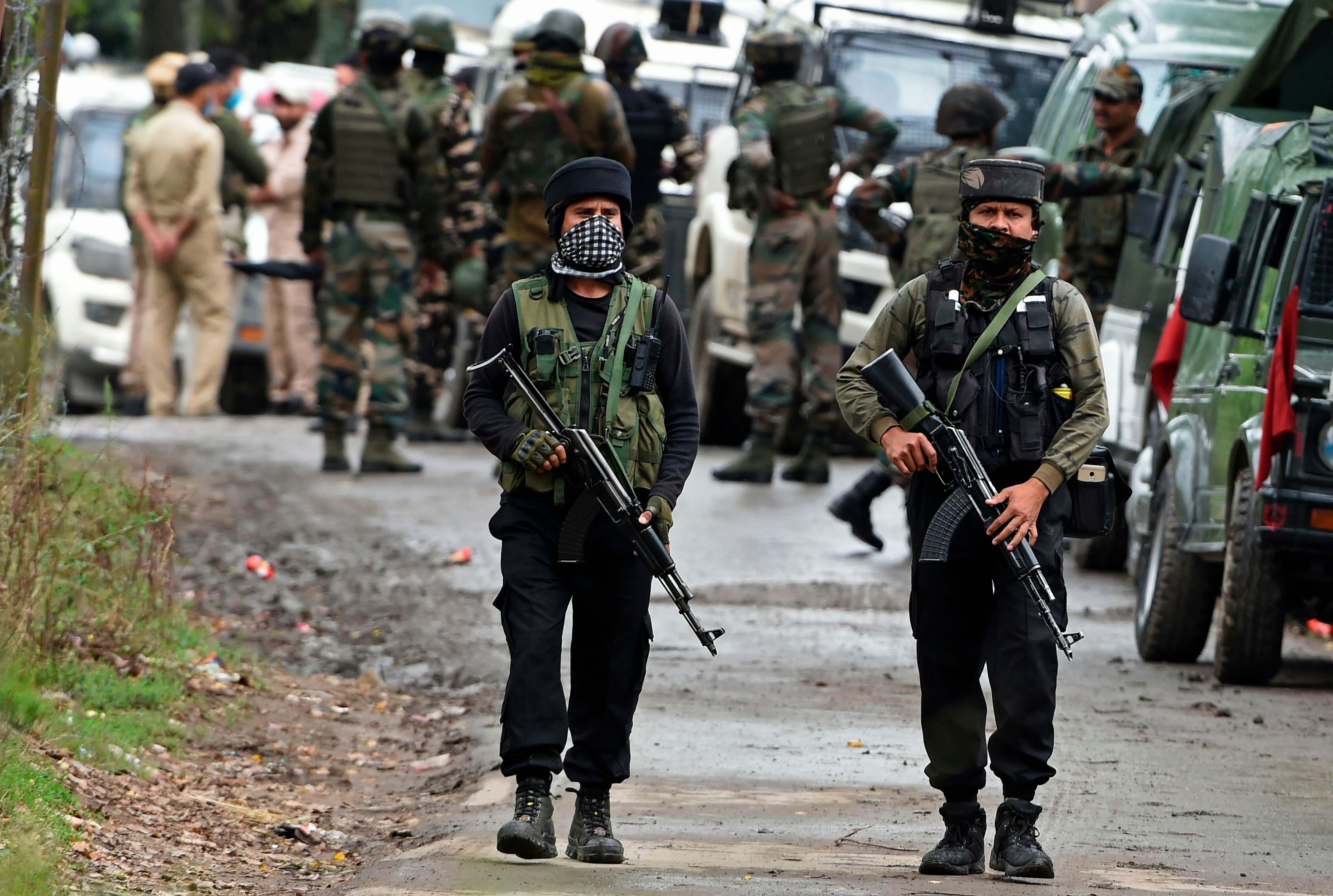 Indian Army soldiers walk near the site of a gunbattle between suspected militants and government forces. Credits: AFP Photo