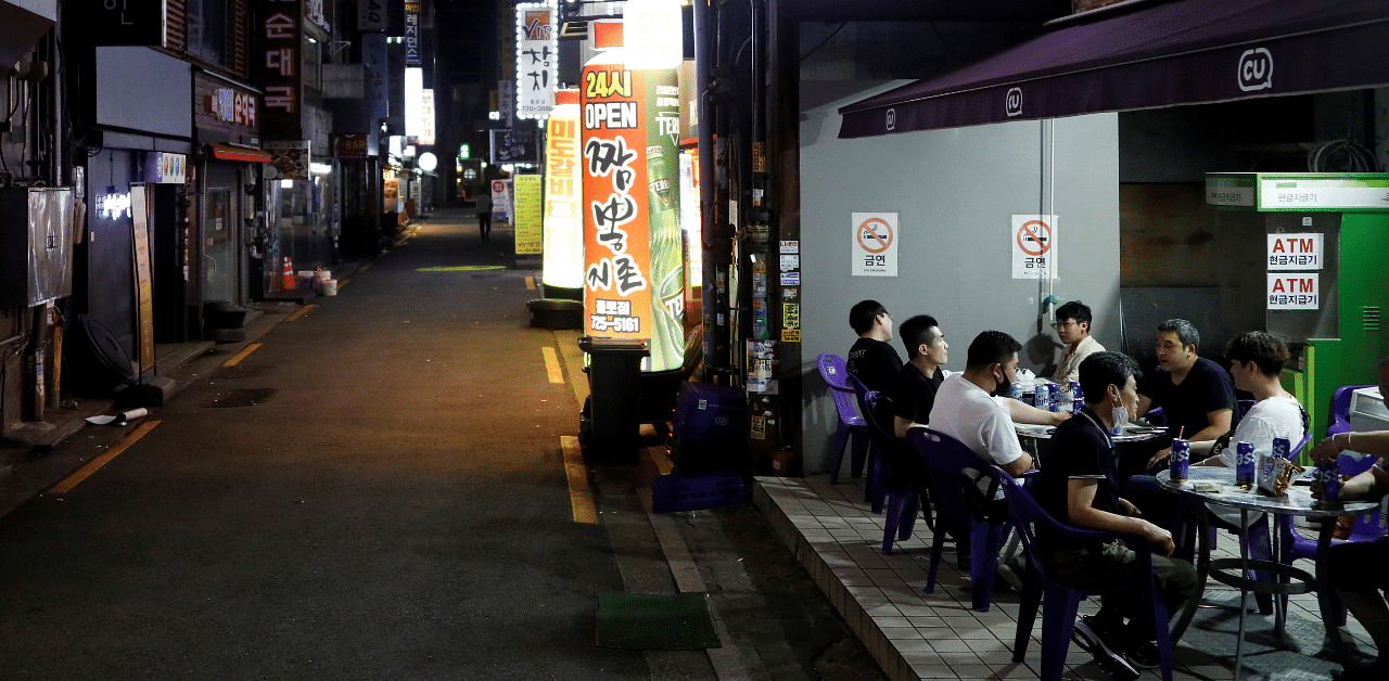 People drink outside in Seoul as tougher social distancing rules continue, South Korea. Credit: Reuters Photo