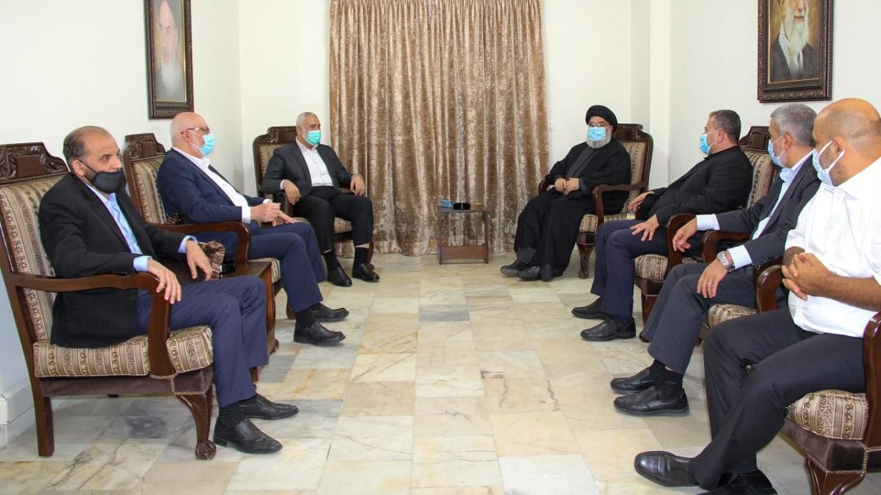 A handout picture released by the Hezbollah press office on September 6, 2020 shows Hassan Nasrallah (C-R), the head of Lebanon's militant Shiite movement Hezbollah, meeting with Hamas' political bureau chief Ismail Haniya (C-L) at an undisclosed location. Credit: AFP