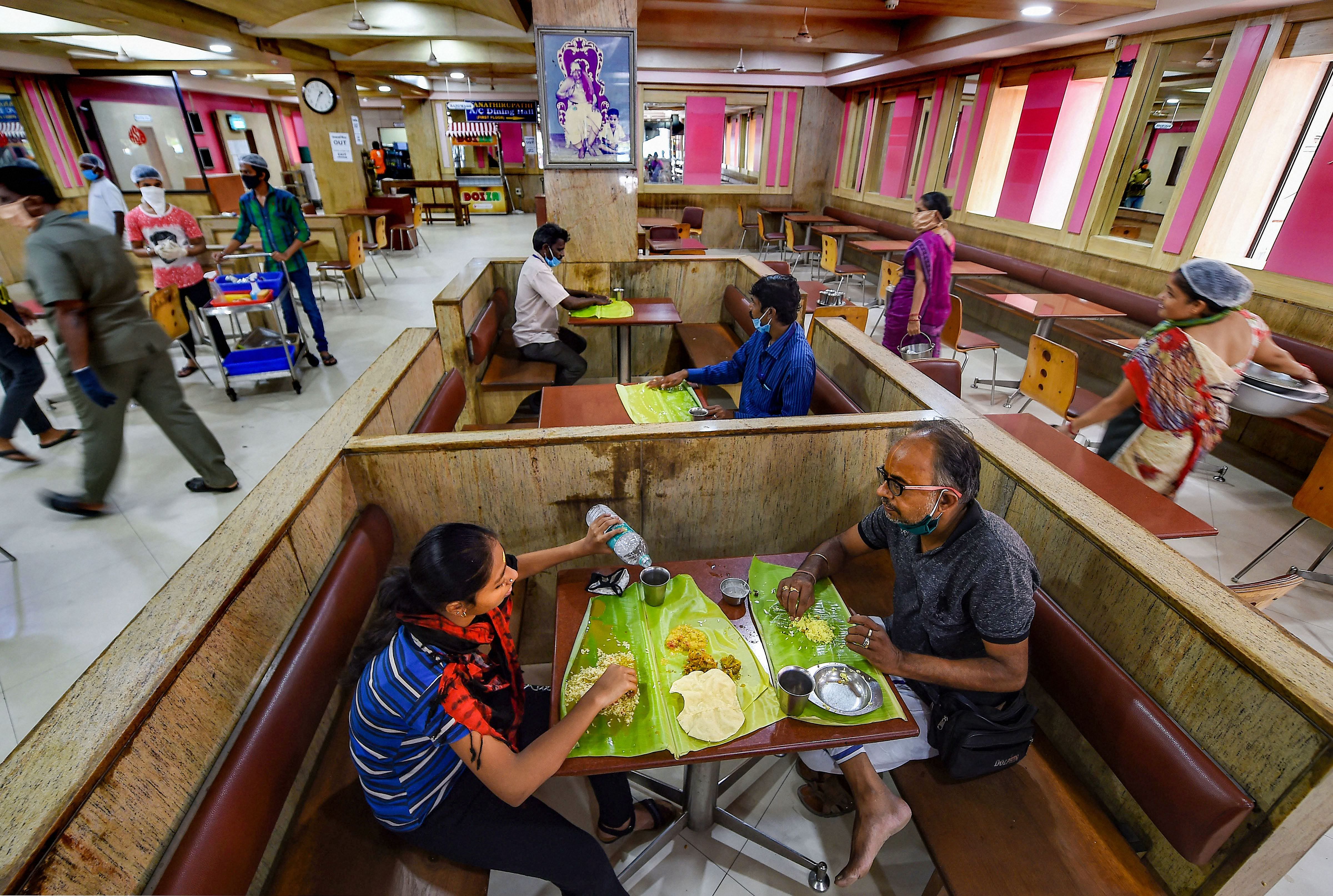 Customers sit inside Saravana Bhavan restaurant after the authorities permitted opening of eateries, during the ongoing COVID-19 lockdown, in Chennai, Monday, June 8, 2020. Credit: PTI Photo