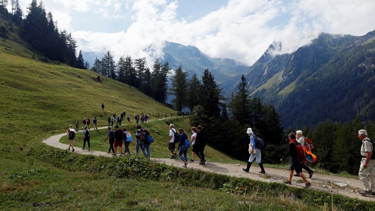Participants walk to the Trient Glacier during protest against climate change, in Trient, Switzerland. Credit: Reuters