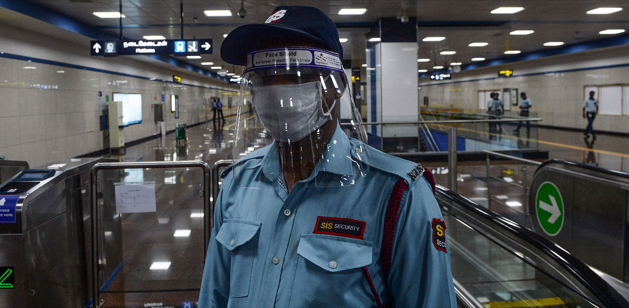 A private security staff poses as he wears a face shield and a facemask during a media preview as the Chennai Metro network prepares to resume services partially after more than 5 months shutdown due to the Covid-19 pandemic. Credit: AFP Photo