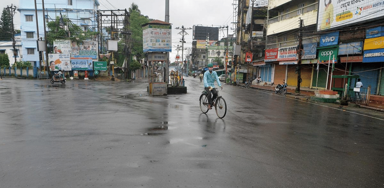 A man cycle past a deserted road during a day-long state-imposed lockdown as a preventive measure against the surge in Covid-19 coronavirus cases. Credit: AFP Photo