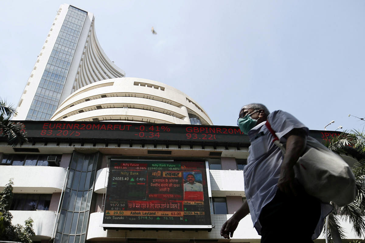 FILE PHOTO: A man wearing a protective mask walks past the Bombay Stock Exchange (BSE) building in Mumbai, India, March 13, 2020. REUTERS File Photo