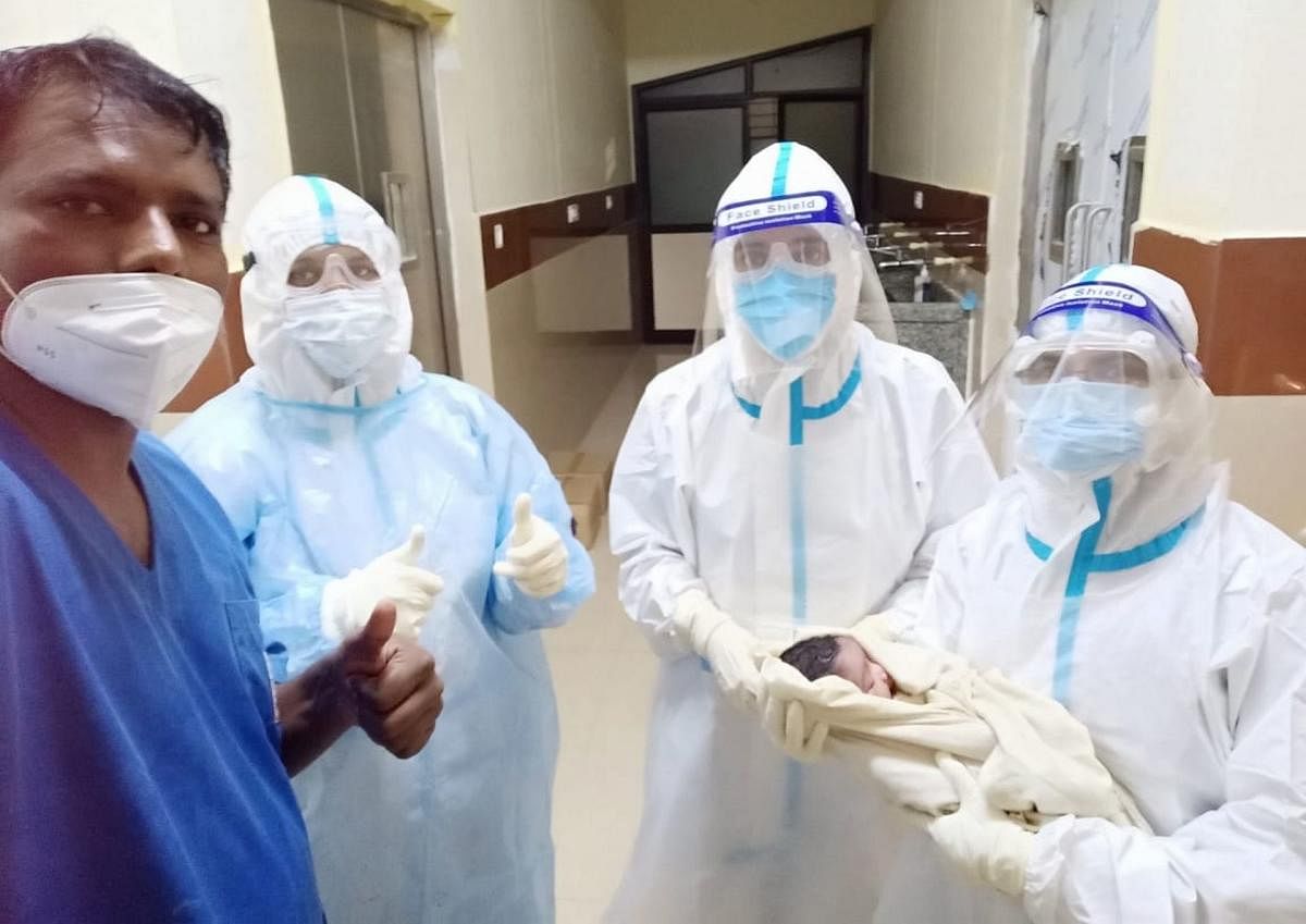 Doctors at the Mandya Institute of Medical Sciences, seen with a newborn, delivered by a Covid positive woman.