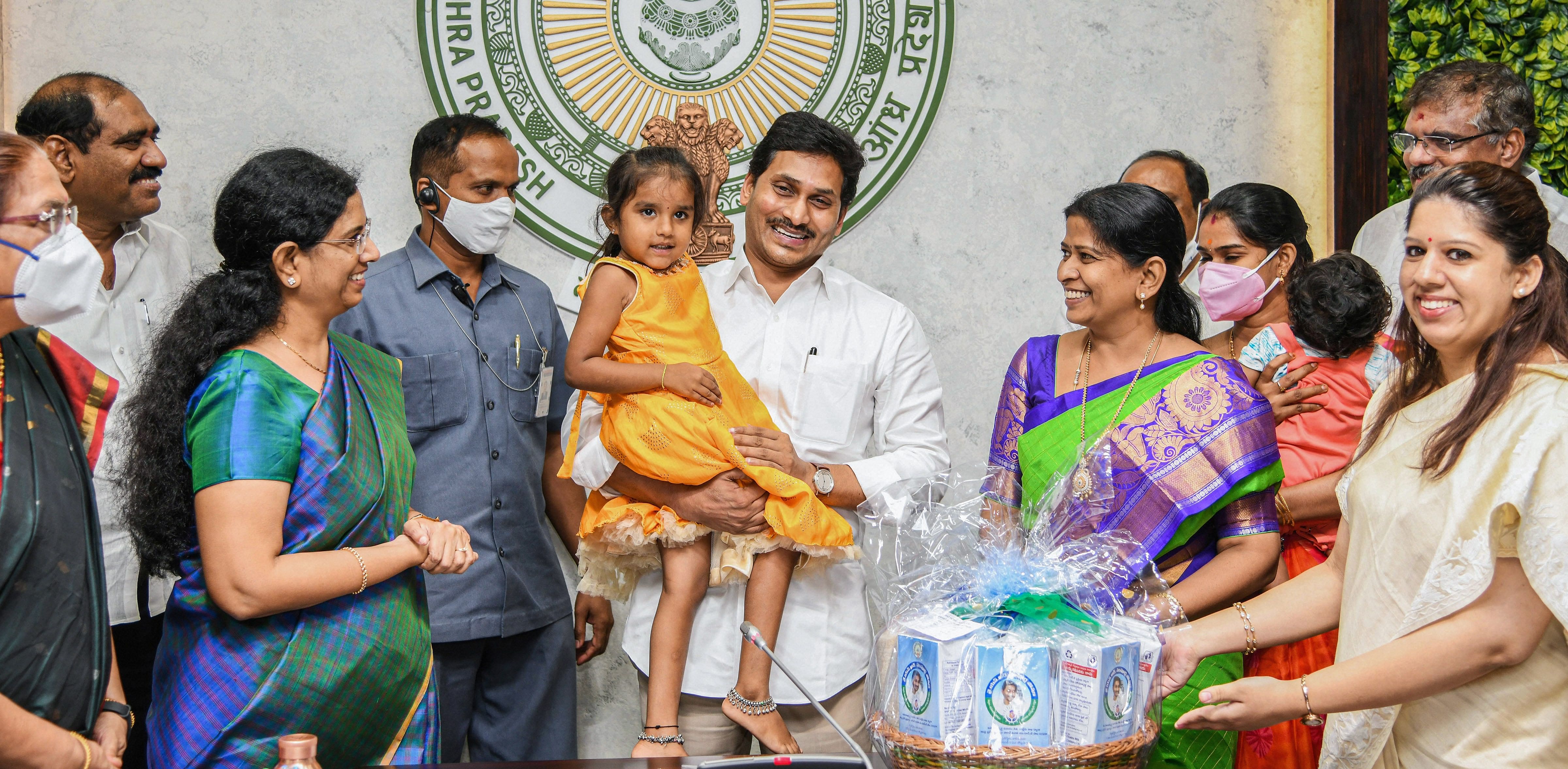 Andhra Pradesh Chief Minister Y S Jagan Mohan Reddy holds a during the inauguration of  YSR Sampoorna Poshana Plus and YSR Sampoorna Poshana schemes for pregnant and lactating mothers, at the Camp Office, Tadepalli in Guntur district, Monday, Sept. 7, 2020. Credit: PTI Photo