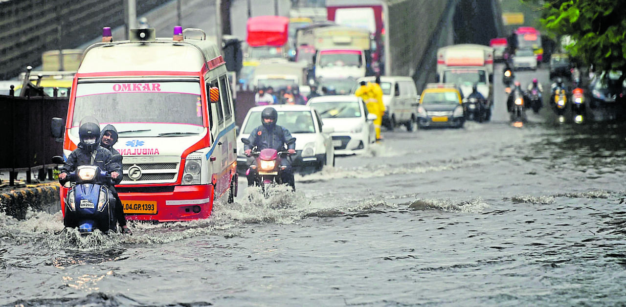 Vehicles move through a waterlogged street as heavy rain continued to lash the city in the aftermath of cyclone Nisarga, at Kings Circle in Mumbai. Credit: PTI Photo