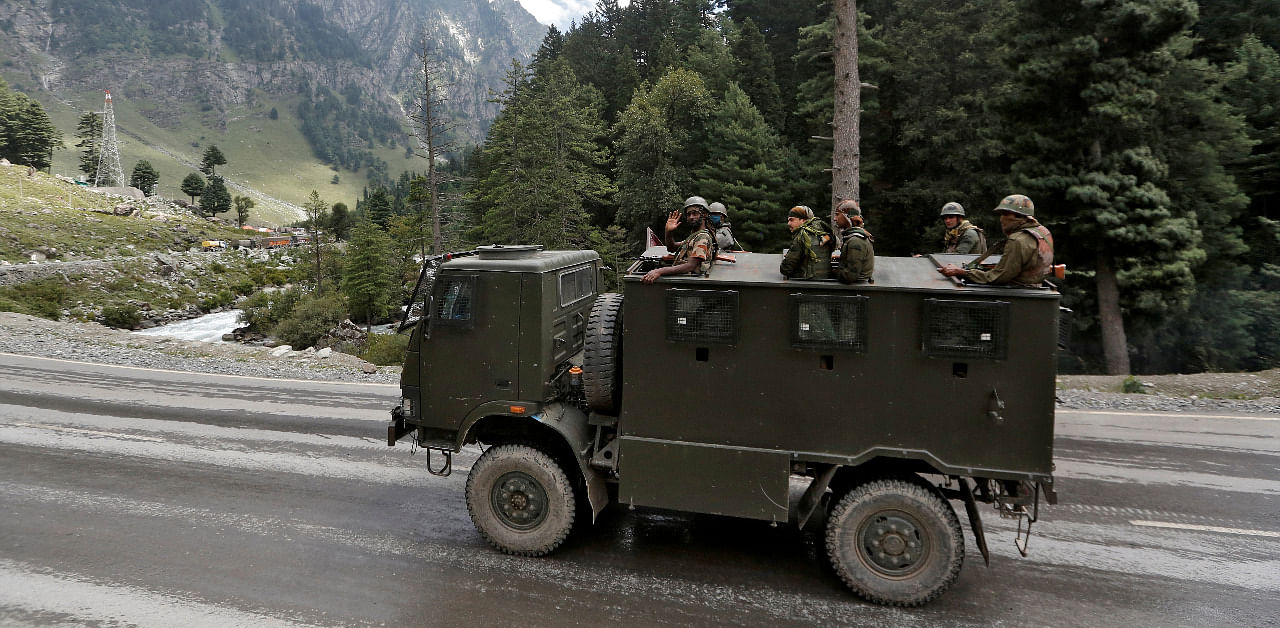 Indian army soldiers are seen atop a vehicle on a highway leading to Ladakh. Credit: Reuters