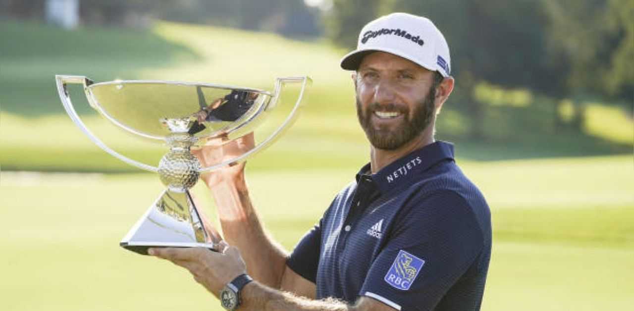 Dustin Johnson celebrates with the FedEx Cup trophy after winning the Tour Championship golf tournament.