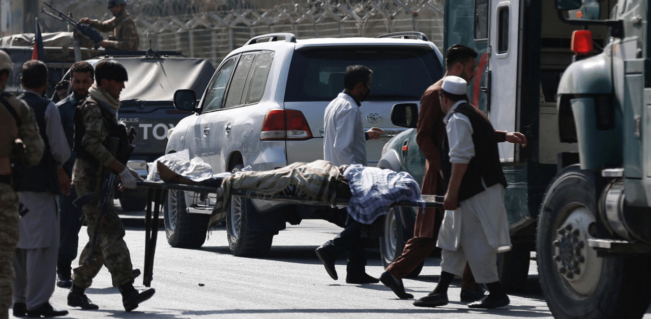 Afghan men carry a victim after a blast in Kabul, Afghanistan. Credit: Reuters Photo