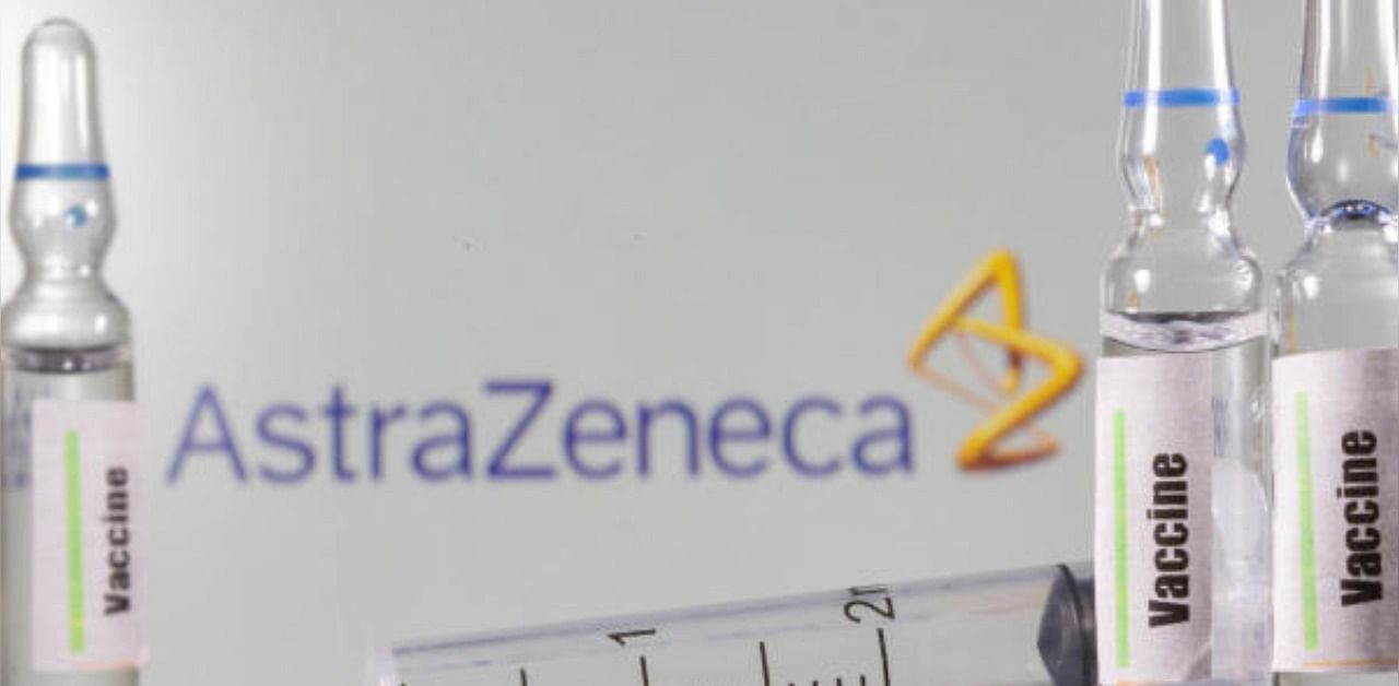 A test tube labelled with the Vaccine is seen in front of AstraZeneca logo. Credit: Reuters