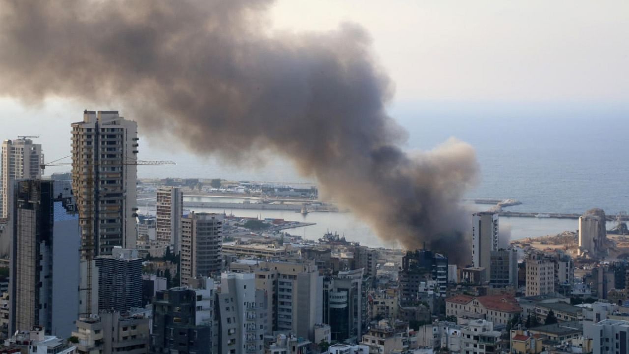 Smoke rises after a fire broke out at Beirut's port area, as pictured from Ashrafieh. Credit: Reuters