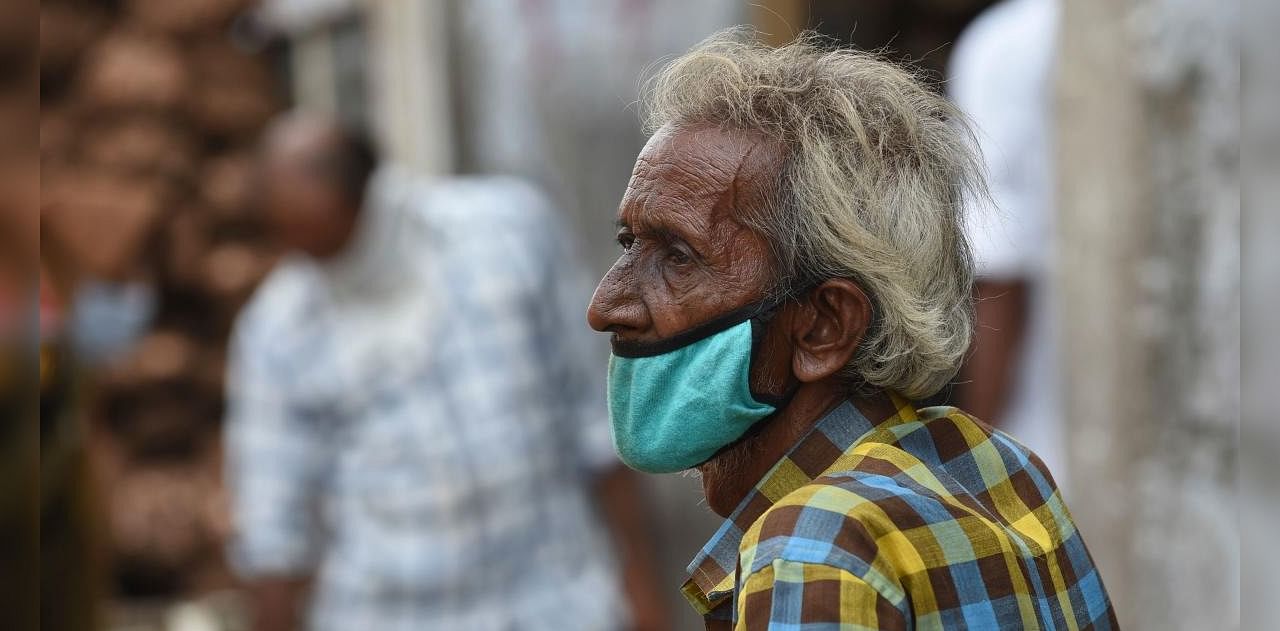 A cycle-rickshaw puller (C) wearing a facemask waits for customers as Jamlpur's Agricultural Produce Market Committee (APMC) reopened after nearly four months of shutdown due to the Covid-19 coronavirus pandemic, in Ahmedabad on September 8, 2020. Credit: AFP Photo