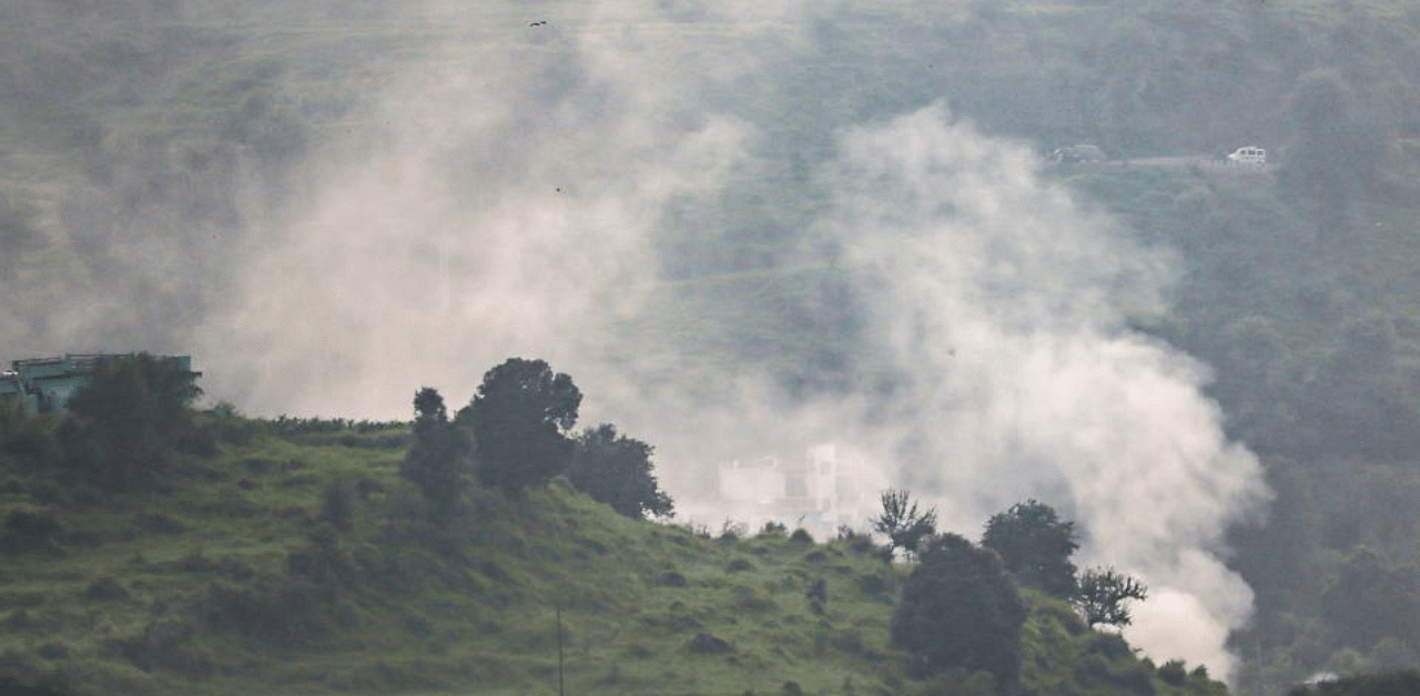 Smoke rises from a mortar shell that was fired by the Pakistani troops along the Line of Control (LoC) at Mankote sector, in Jammu and Kashmir''s Poonch district. Credit: PTI File Photo