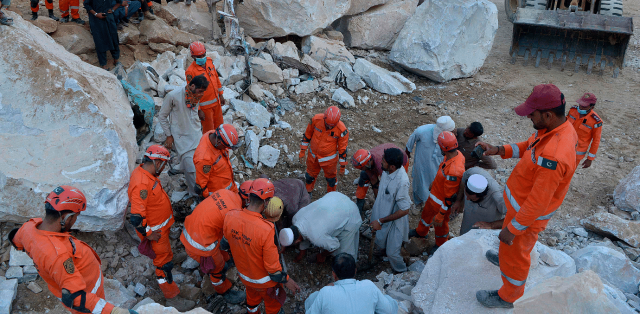 Army rescuers take part in a rescue search for miners after a rockslide at a marble mine in the mountainous Mohmand district in Khyber-Pakhtunkhwa province. Credit: AFP Photo