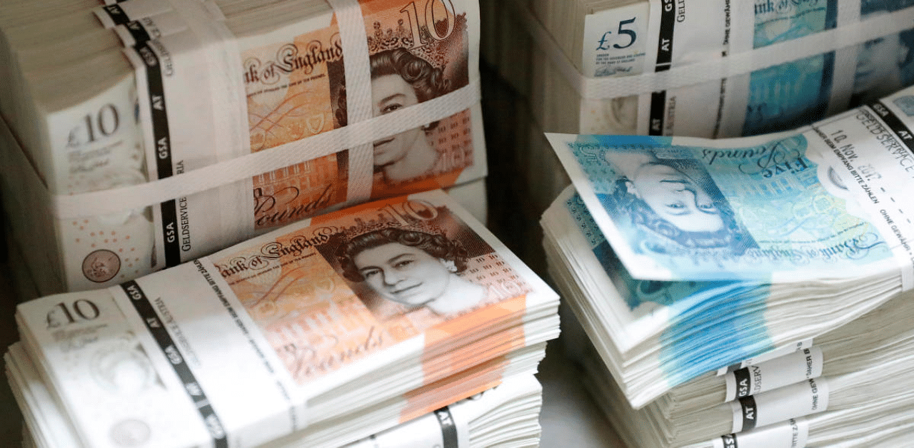 British sterling banknotes stacked in piles. Credit: Reuters Photo