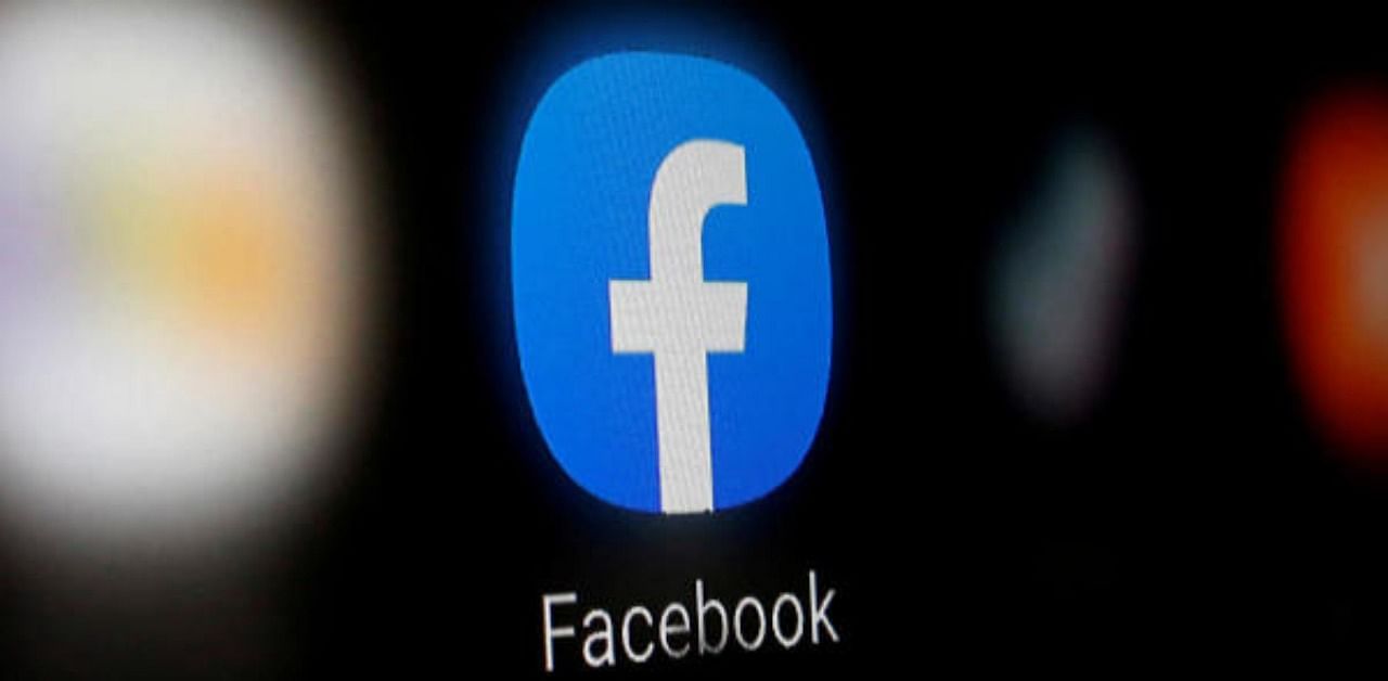 A Facebook logo is displayed on a smartphone. Representative Photo. Credit: Reuters