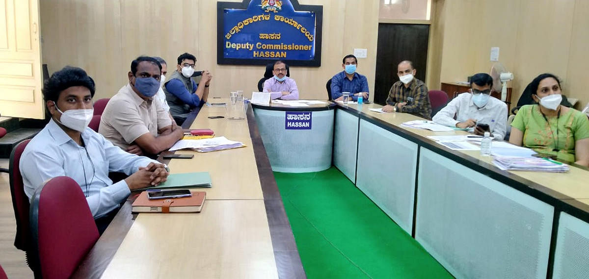 Deputy Commissioner R Girish and officials during a video conference with Health Minister B Sriramulu in Hassan on Thursday. DH PHOTO