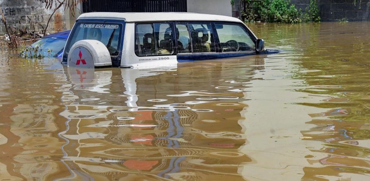 A car submerged partially in a waterlogged area following heavy rains overnight, at Horamavu in Bengaluru, Wednesday, Sept. 9, 2020. (PTI Photo)