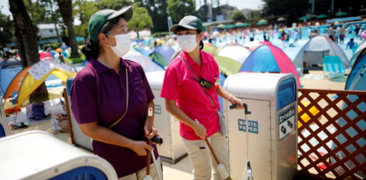 Employees of Toshimaen amusement park, conduct a cleaning work together, amid the coronavirus disease. Representative Photo. Credit: Reuters