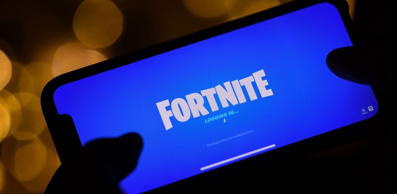  A person logging into Epic Games' Fortnite on their smartphone in Los Angeles. Credit: AFP
