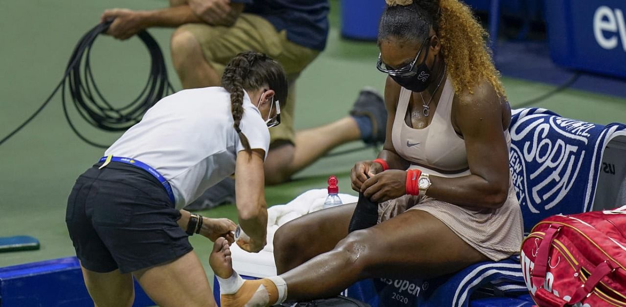 Serena Williams, of the United States, has her ankle taped by a trainer during a medical timeout during a semifinal match of the US Open. Credit: AP/PTI