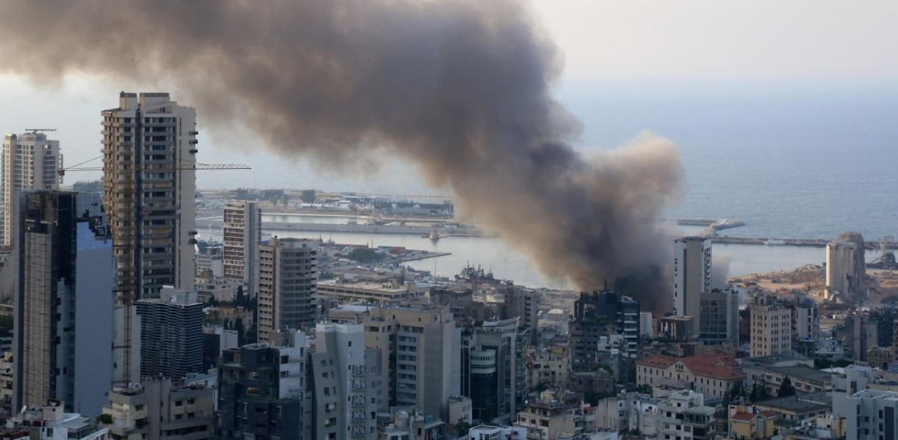 Smoke rises after a fire broke out at Beirut's port area. Credit: Reuters
