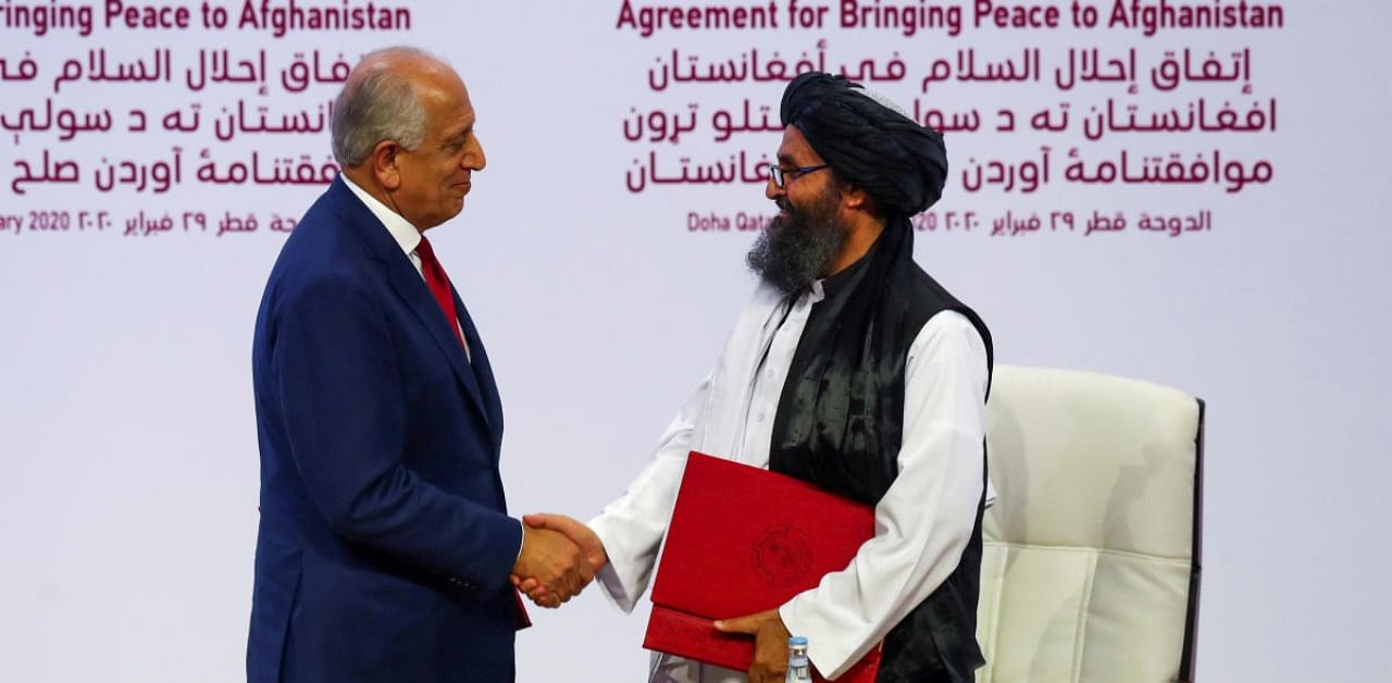 Mullah Abdul Ghani Baradar, the leader of the Taliban delegation, and Zalmay Khalilzad, US envoy for peace in Afghanistan. Credit: Reuters