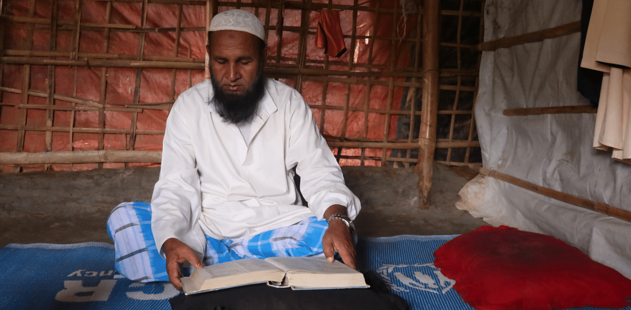 Mohammed Rofiq, a Rohingya refugee, reads Islamic scripture in his home in Kutupalong refugee camp, in Cox's Bazar, Bangladesh. Credit: Reuters Photo