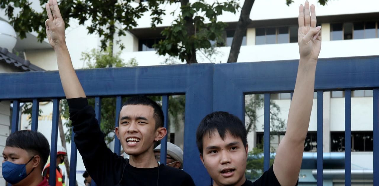 Tattep Ruangprapaikitseree and Panumas Singprom flash the three-fingers salute. Credit: Reuters Photo