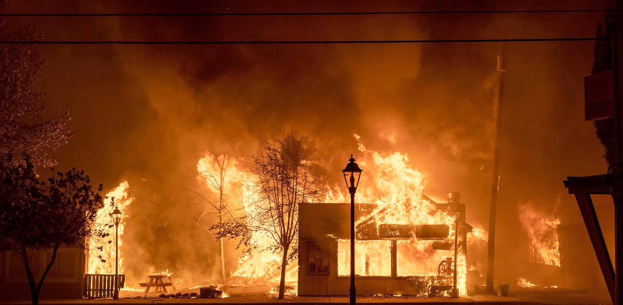 Buildings are engulfed in flames as a wildfire ravages the central Oregon. Credit: AP