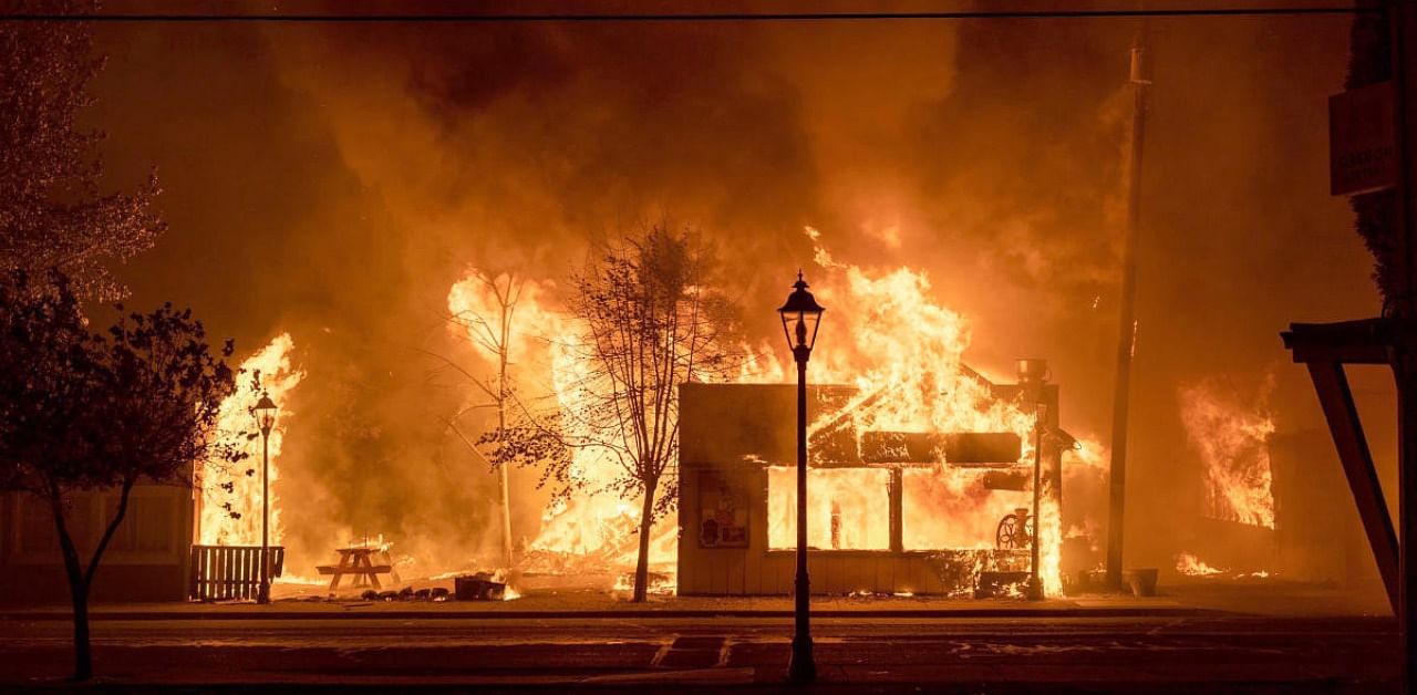 Buildings are engulfed in flames as a wildfire ravages the central Oregon town of Talent near Medford. Credit: AP