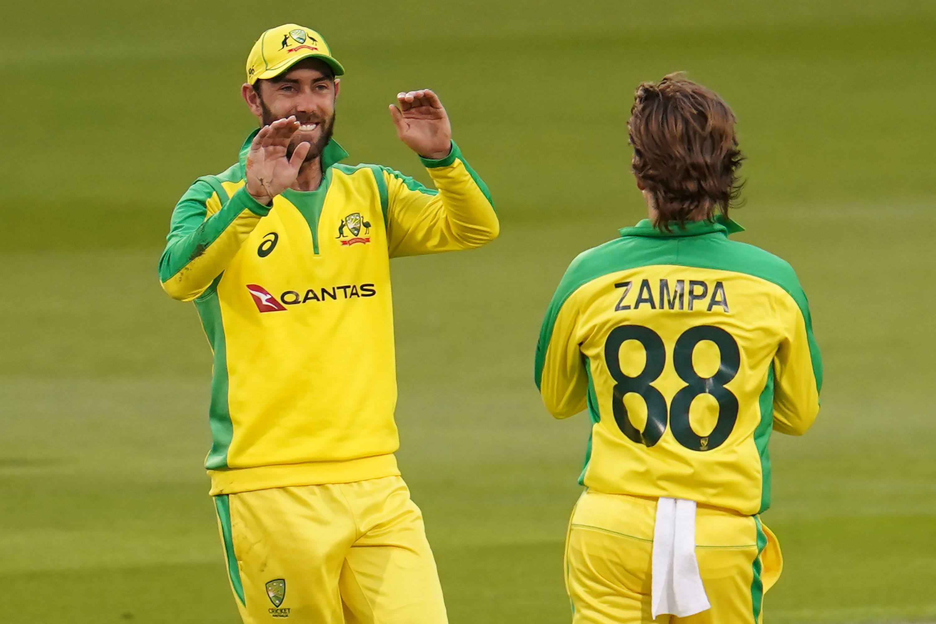 Australia's Glenn Maxwell (L) celebrates with Australia's Adam Zampa after taking a catch to dismiss England's Eoin Morgan during the one-day international (ODI) cricket match between England and Australia at Old Trafford in Manchester on September 11, 2020. Credit: AFP Photo
