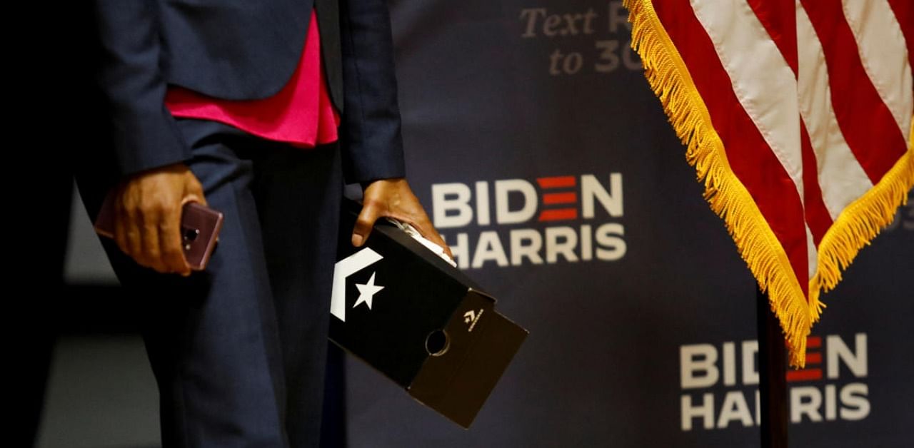 A staff member of Democratic US vice presidential nominee Senator Kamala Harris holds a box of Converse shoes as Harris attends a Community Conversation with African-American Leaders, in Miami, Florida. Credit: Reuters