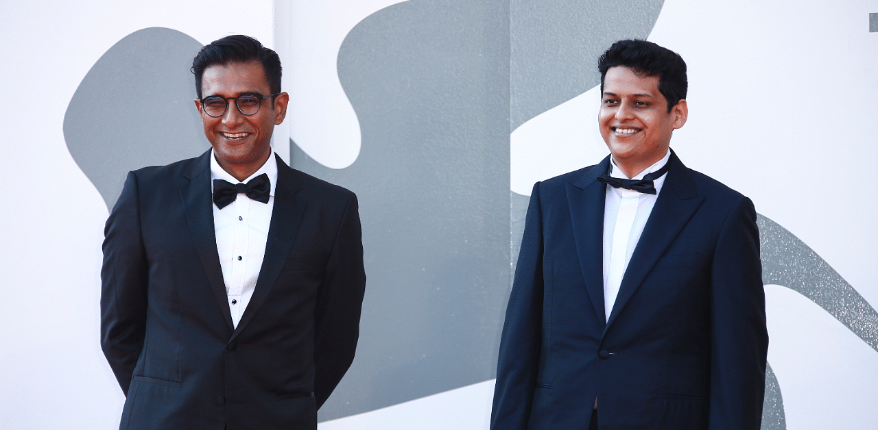 Director Chaitanya Tamhane (R) and producer Vivek Gomber pose for photographers upon arrival at the premiere of the film 'The Disciple' during the 77th edition of the Venice Film Festival in Venice, Italy. Credit: AP Photo