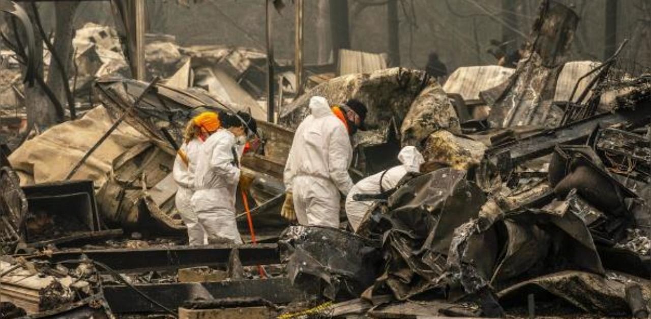 Search and rescue personnel from the Jackson County Sheriff's Office look for the possible remains of a missing elderly resident in a mobile home park on September 11, 2020 in Ashland, Oregon. Credit: AFP Photo