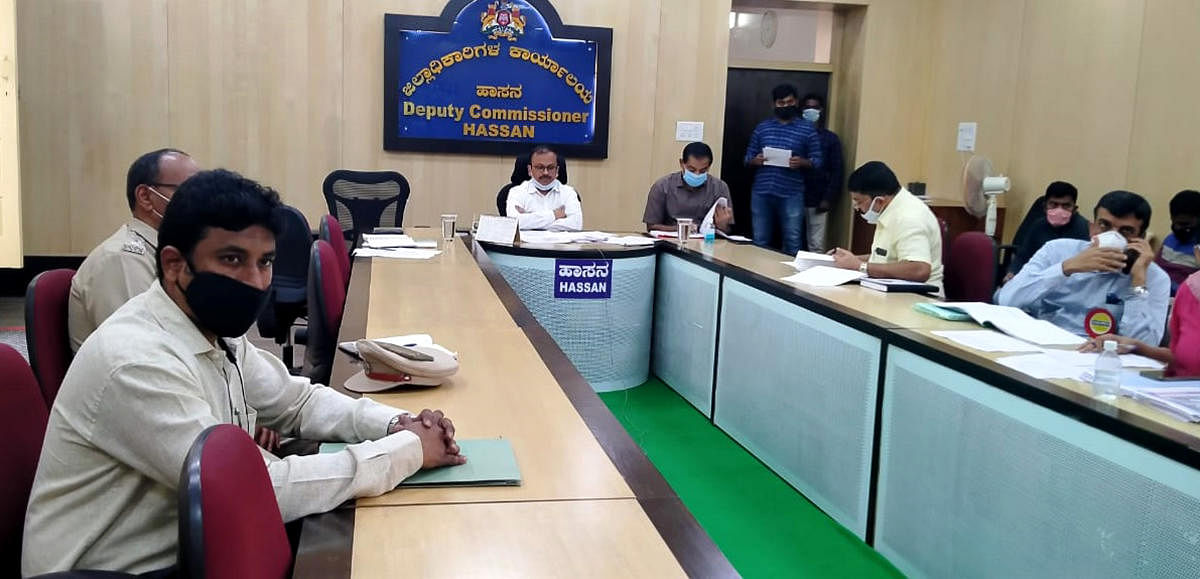 District-level officials attend a video conference, addressed by Chief Minister B S Yediyurappa in Hassan on Saturday. DH PHOTO