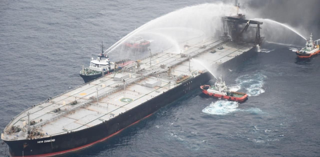 A Sri Lankan Navy boat sprays water on the New Diamond, a very large crude carrier (VLCC) chartered by Indian Oil Corp (IOC). Credit: Reuters