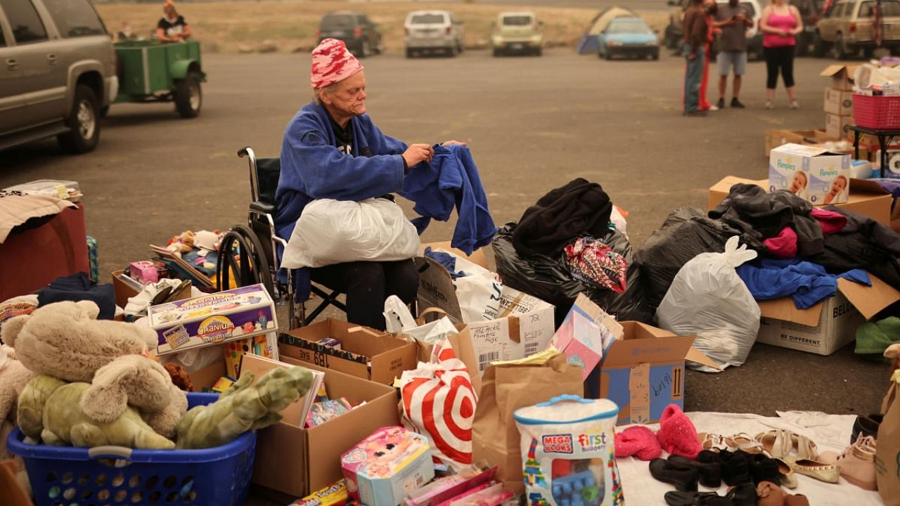 A woman is seen at a supplied makeshift distribution center for people displaced by the wildfires at a parking lot in Oregon City. Credit: Reuters