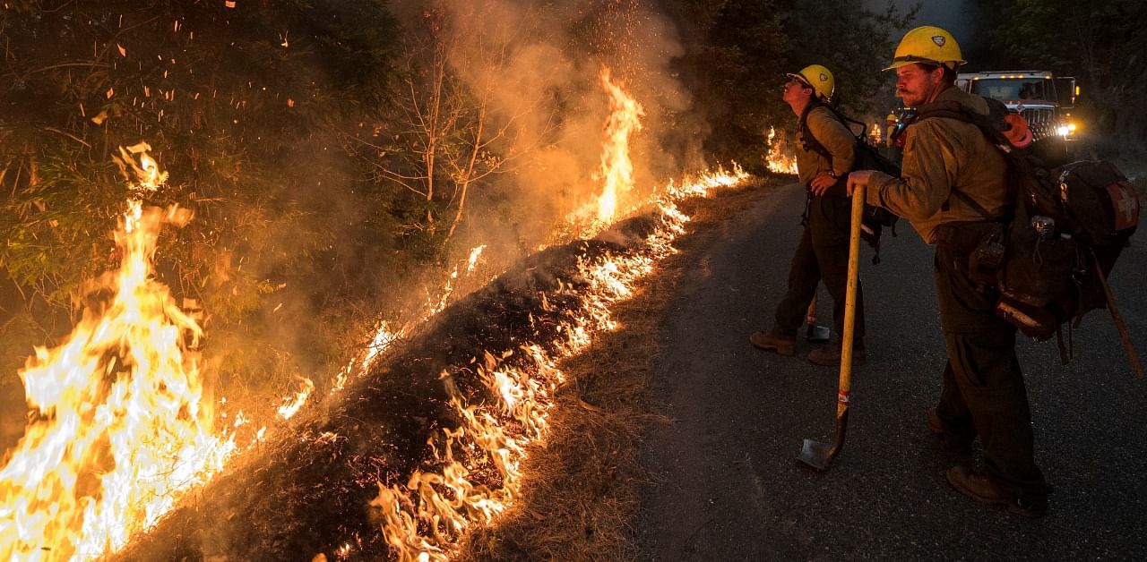 Firefighters monitor a controlled burn along Nacimiento-Fergusson Road to help contain the Dolan Fire near Big Sur, California. Credit: AP Photo