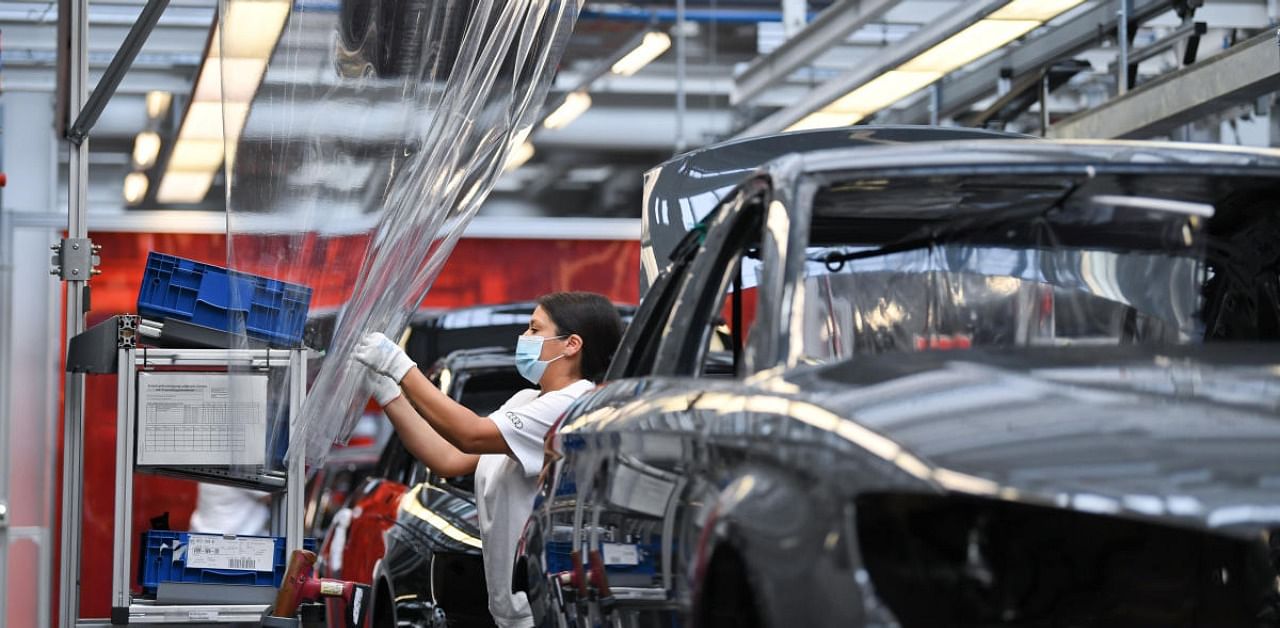  Employees, separated by plastic hygiene protection, work at the A3 and A4 production line of the German car manufacturer Audi, amid the spread of the coronavirus disease. Credit: Reuters