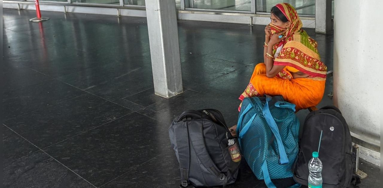 A passenger waits at NSCBI Airport wearing almost a deserted look during the bi-weekly lockdown in the wake of coronavirus pandemic, in Kolkata. Credit: PTI Photo