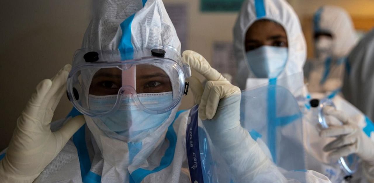 Medical workers wear personal protective equipment (PPE) as they get ready to treat patients suffering from the coronavirus disease, at the Max Smart Super Speciality Hospital in New Delhi. Credit: Reuters