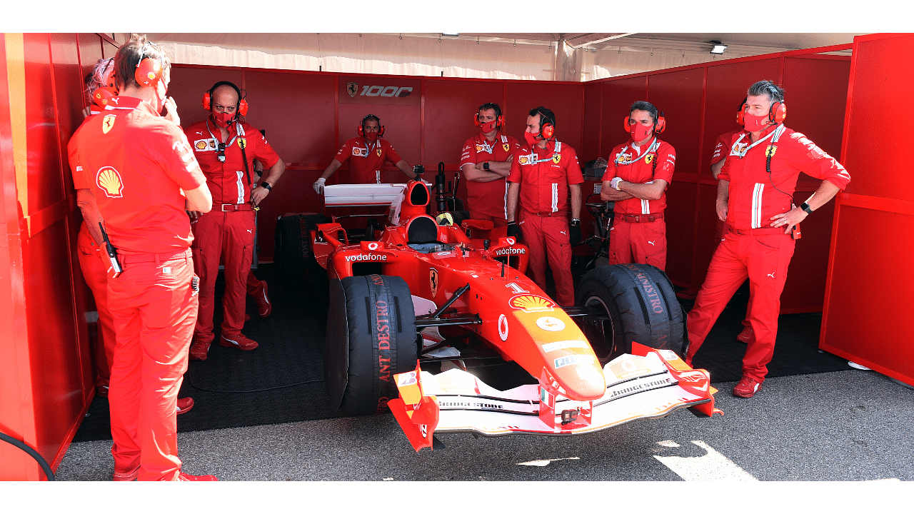 2020 Ferrari team members prepare the Ferrari F2004 of Michael Schumacher for a display run before the race Pool. Credits: Reuters Photo