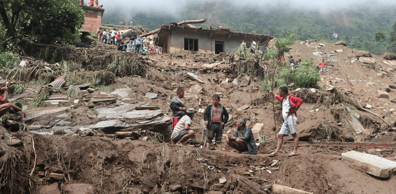 Residents and rescue workers search for bodies of landslides victims. Credit: AFP