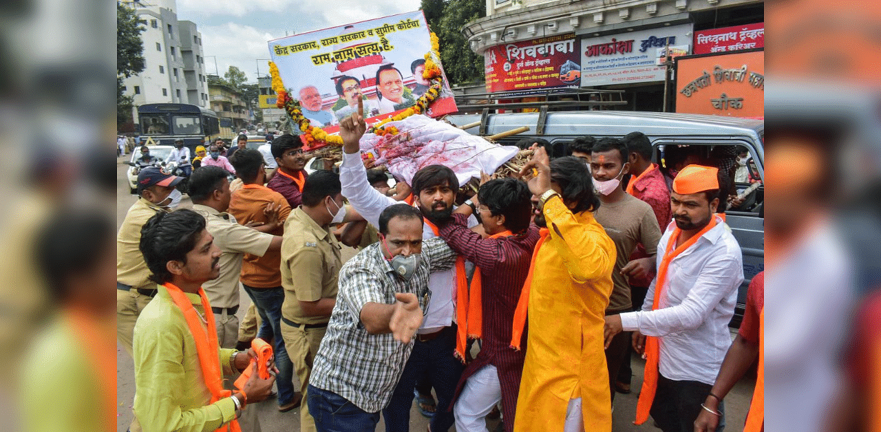  Policemen stop Maratha Kranti Morcha activists as they take out a mock funeral procession during a protest demanding reservation for their community, in Solapur, Sunday, Sept. 13, 2020. Credit: PTI Photo