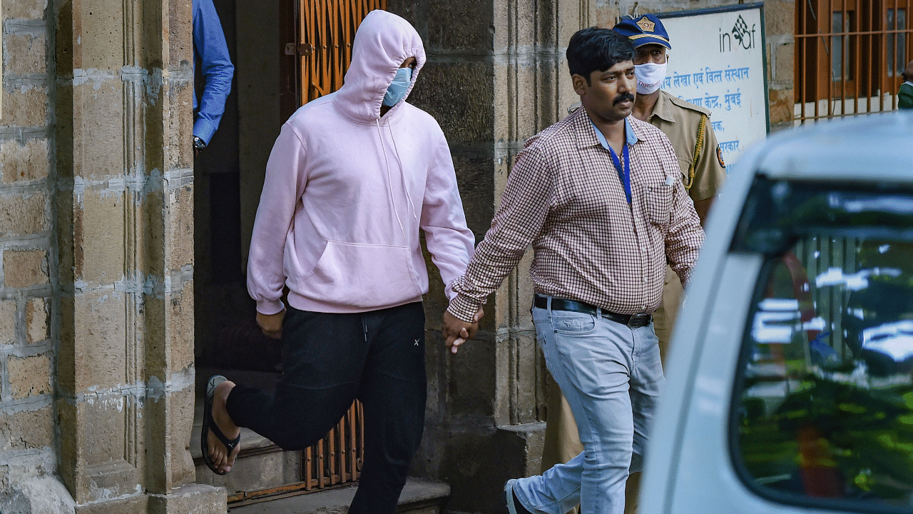 Narcotics Control Bureau officers take alleged drug peddler Zaid Vilatra, accused in connection with Sushant Singh Rajput's death case, to the court, in Mumbai. Credits: PTI Photo