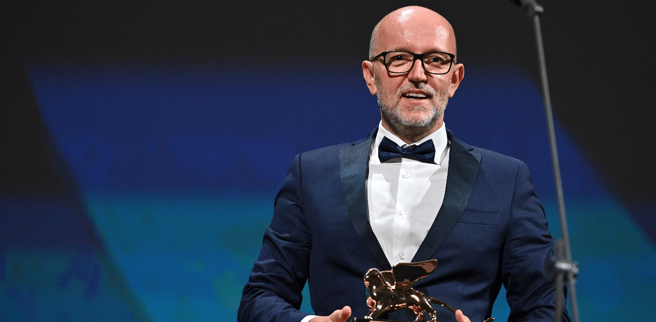 Disney's Marketing Director for Italy, Davide Romani acknowledges receiving the Golden Lion for Best Film on behalf of US director Chloe Zhao for "Nomadland" during the closing ceremony on the last day of the 77th Venice Film Festival. Credit: Reuters Photo