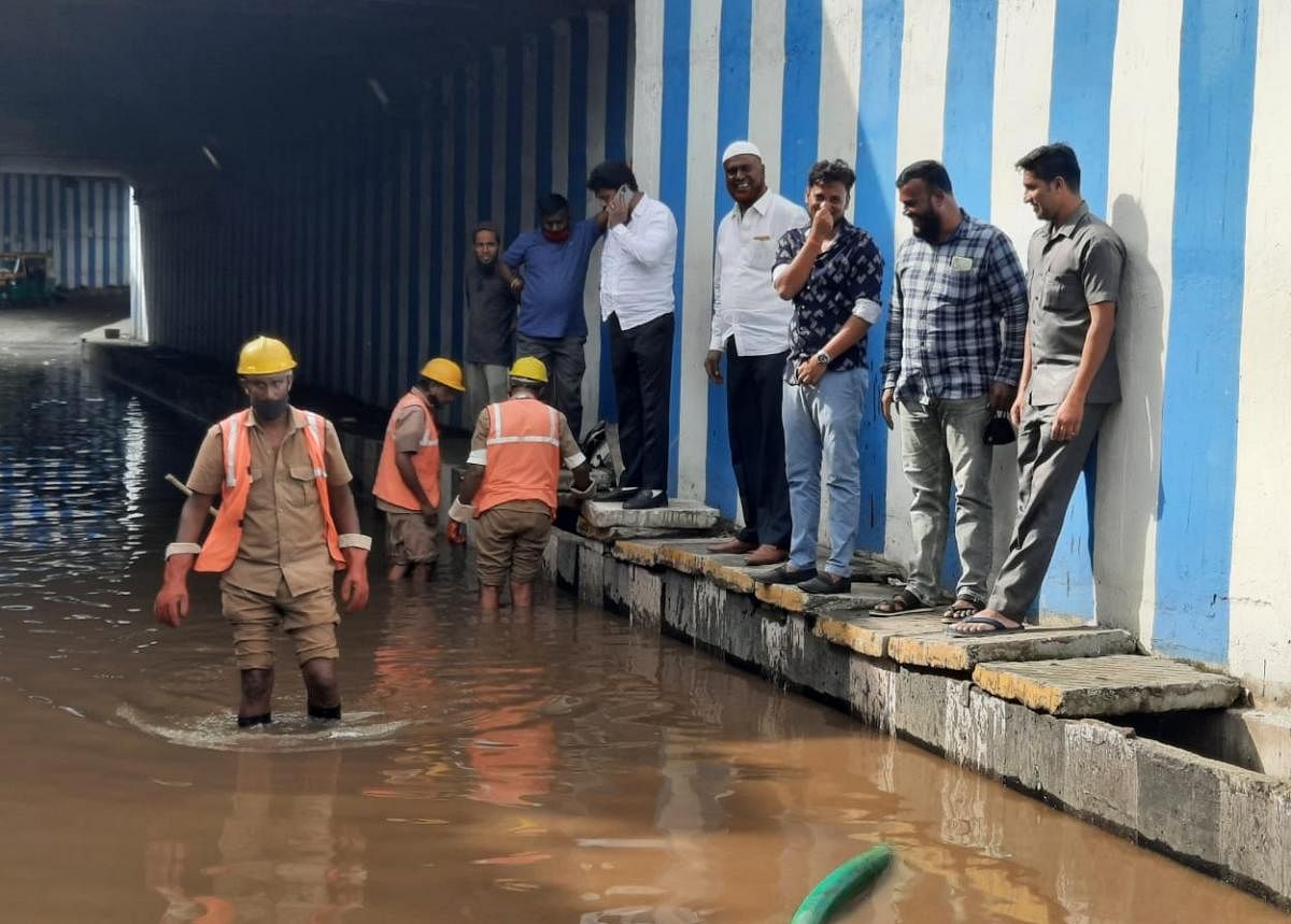 BBMP Workers removing rain water following heavy rains triggered floods in Shamannanagar underpass, in Bengaluru on Monday